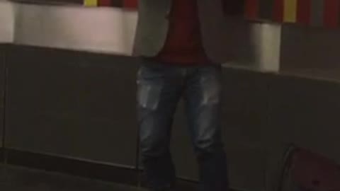 A man wearing a white wolf dog mask playing the violin in the montreal metro system.