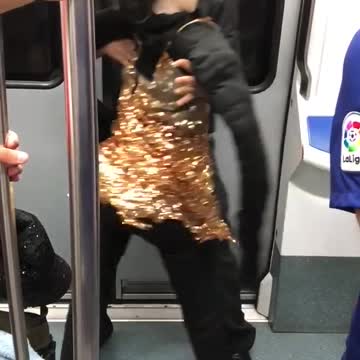 Man in black dancing with doll in gold