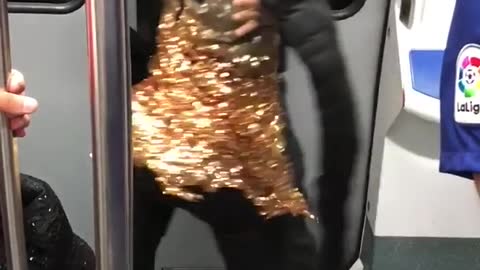 Man in black dancing with doll in gold