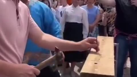 Strongman Dmitry Khaladzhi driving in a nail with his hand