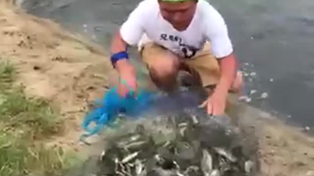 Fishing by net in small river