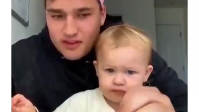 Child drops all juice on table in front of father