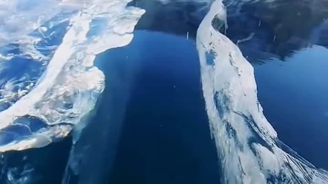 The clear lake water is transparent after connecting to the ice