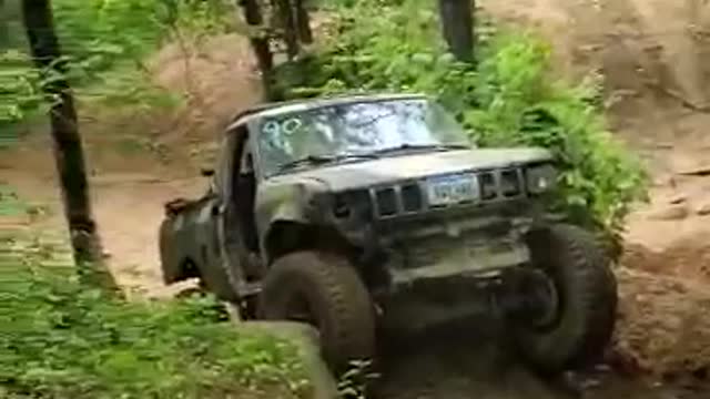 4x4 Toyota crawling (bouncing?) SUV-sized rock