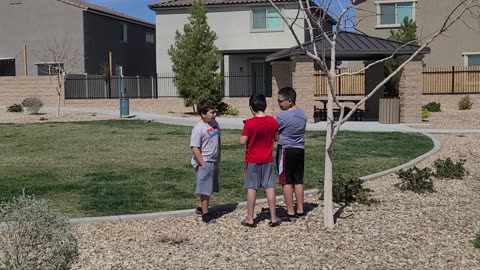 Son flys the drone with cousins