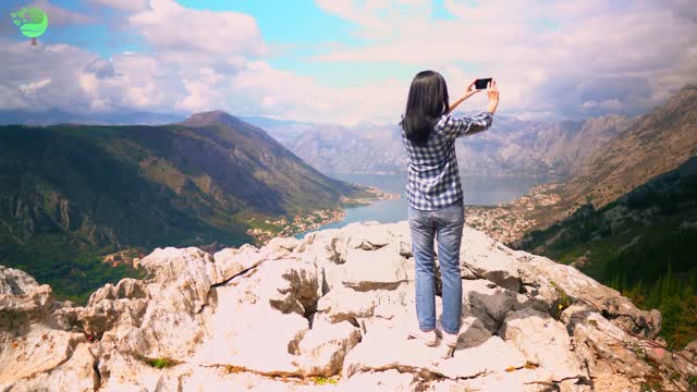 climber using smartphone shoot mountain nature landscape in summer