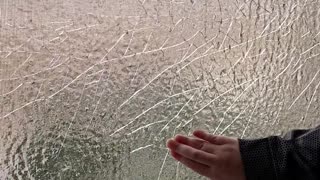 Breaking up Ice on Frozen Window Screen