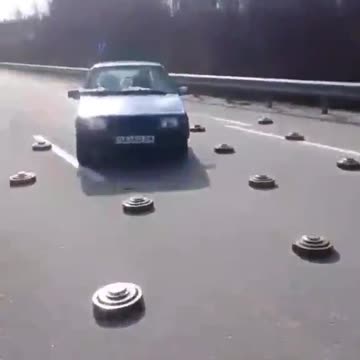 Drivers dodge mines on a highway near kyiv.