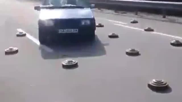 Drivers dodge mines on a highway near kyiv.