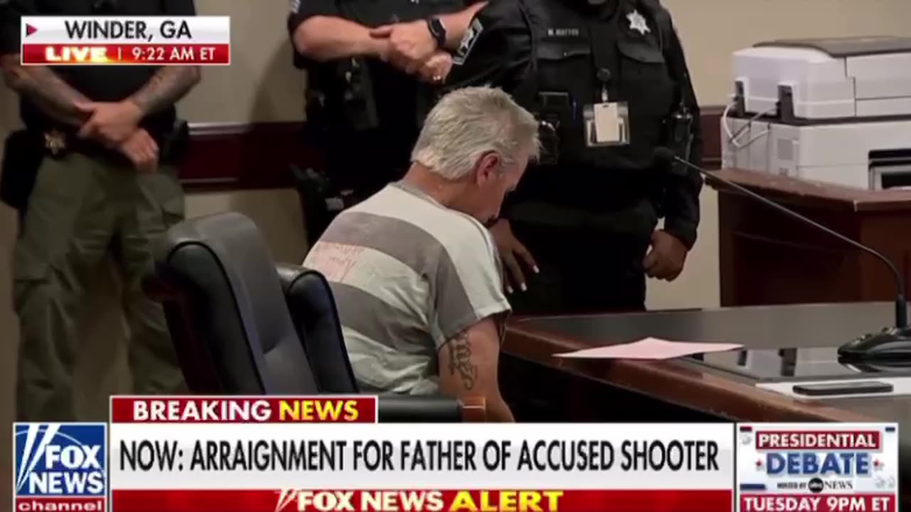 Cameraman zooms in on tattoo on the father of accused shooter