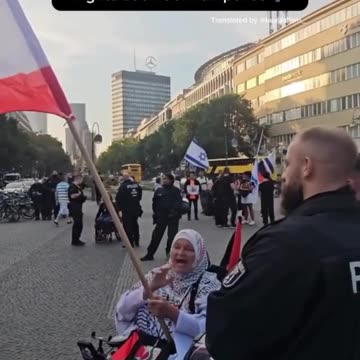 Elderly Woman Rocks While Chaos Unfolds Behind Her in Germany's Genocide Scene
