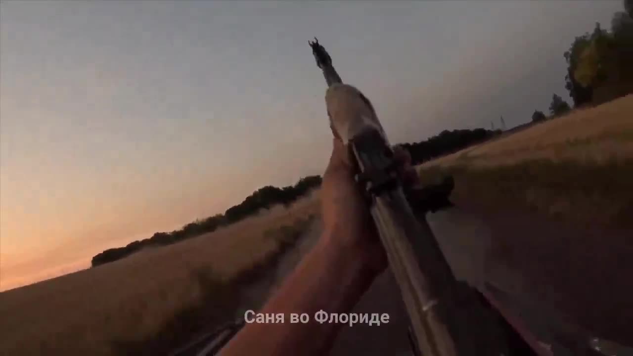 Russian soldiers fighting off a Ukrainian drone.