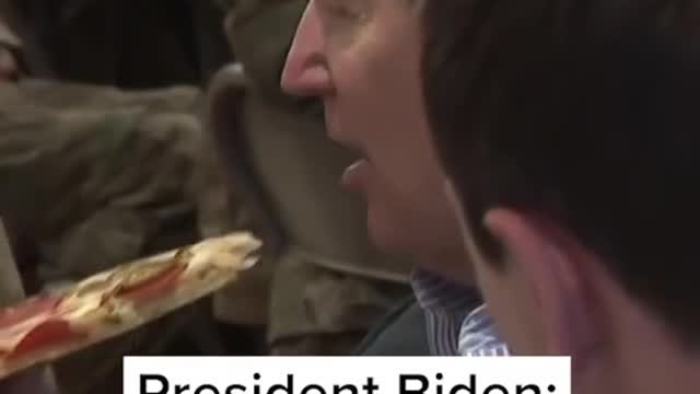 President Biden sits down for a slice of pizza with U.S. troops