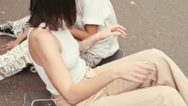 Women Sitting on Skateboards