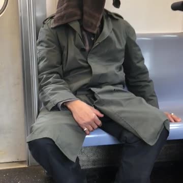 Man sleeps with brown towel on face