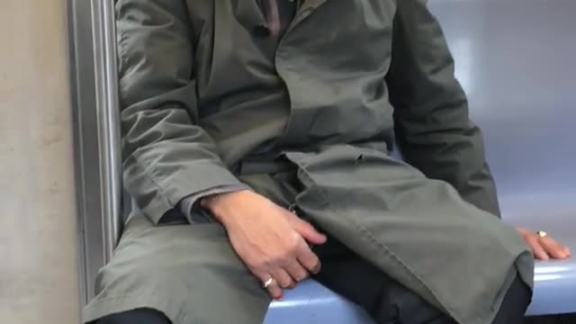 Man sleeps with brown towel on face