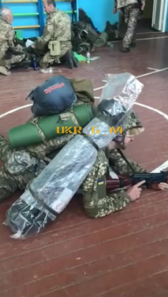 Ukraine military with weapons inside school gym