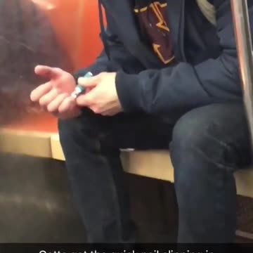 Man clipping nails beanie blue jacket