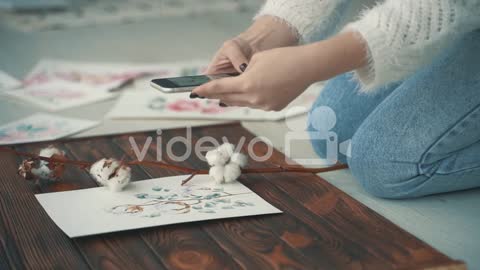 Young Female Creator Taking Photos Of Her Illustrations 1