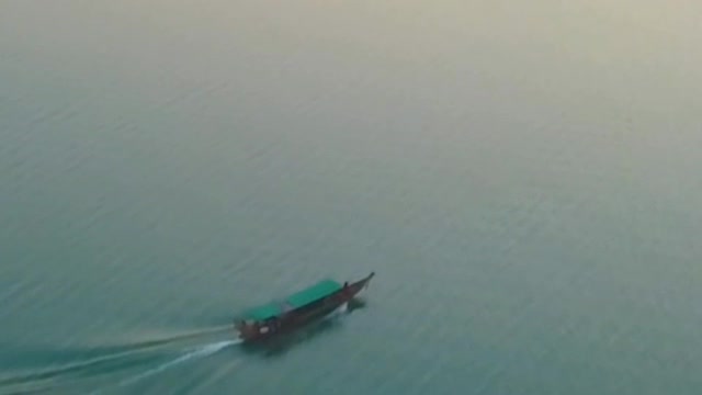 Motorboat on a large lake with turquoise blue waters