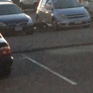 Guy does pushups between cars before going out to surf