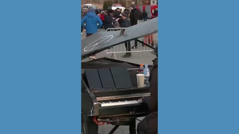 Man plays piano at Ukrainian-Polish border