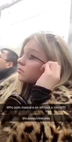 Girl puts on mascara without mirror on subway train
