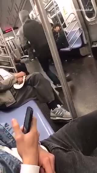 Guy grey hoodie dancing on subway