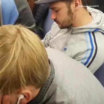 Man in black hat falls asleep on other mans back