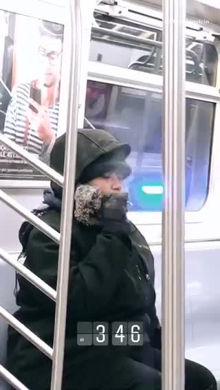 Woman smokes on subway train