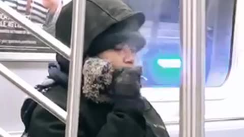 Woman smokes on subway train 