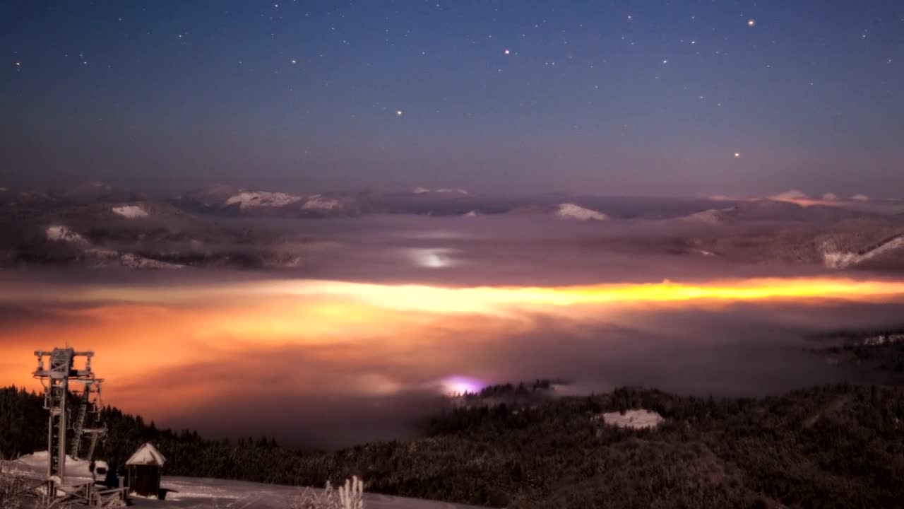 Landscape with illuminated clouds at night