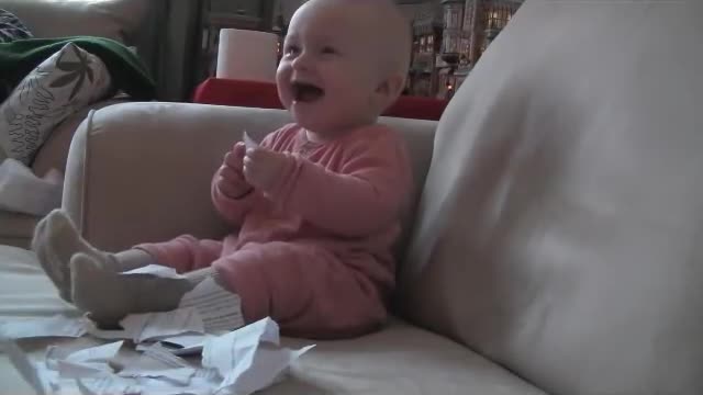 He laughs when the paper is torn off