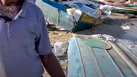Palestinian fisherman transforms a refrigerator door into a boat