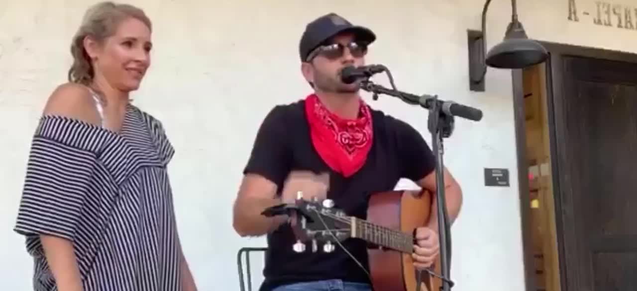 Woman climbs on stage and appears to cough on singer in Texas