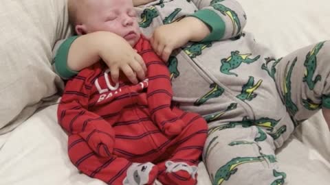 Big brother adorably cuddles with newborn baby