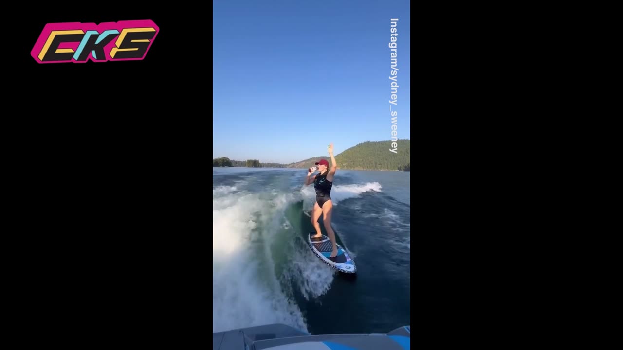 Sydney Sweeney drinks a Bai while water surfing for first time