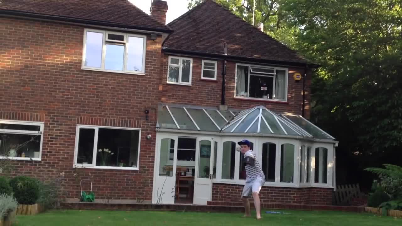 Boy Smashes a Window With a Baseball