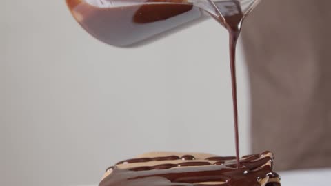 A Man pounding chocolate syrup on pan cake.😋