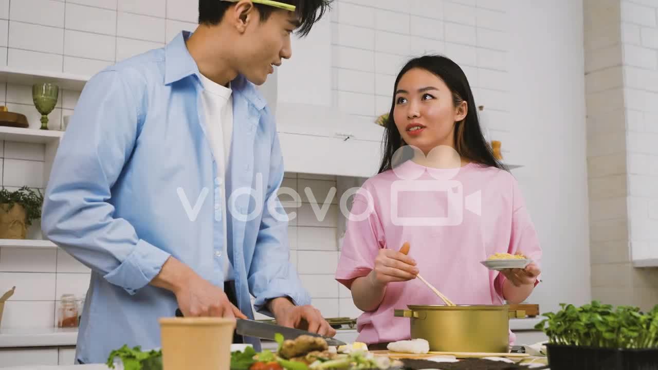 Japanese Couple Cooking Japanese Food While Talking And Laughing In The Kitchen 1