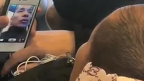 Guy facetiming woman while laying down on train