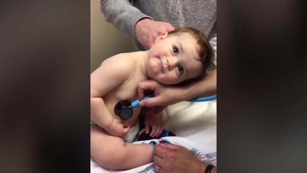 Sweet Baby Boy Rests Head On Nurse's Hand During Check-up