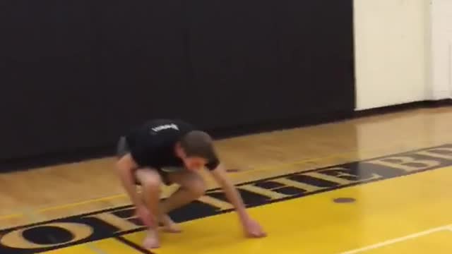 Guy goes for dunk off of chair and falls on back basketball court