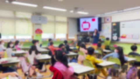 Blurred, students in elementary school classrooms with teachers