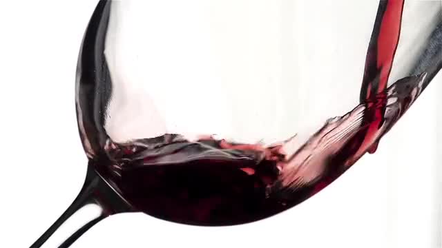 The wine pours into the glass.