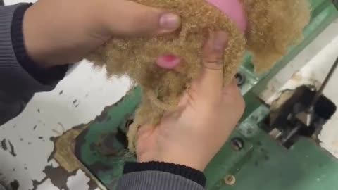Dollmaker Sews On Curly Hair