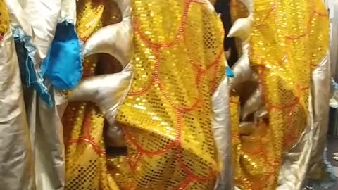 People carrying gold dragon costume in train