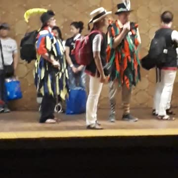 People playing flute and drums on subway station
