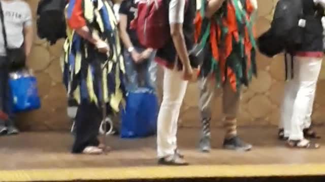 People playing flute and drums on subway station