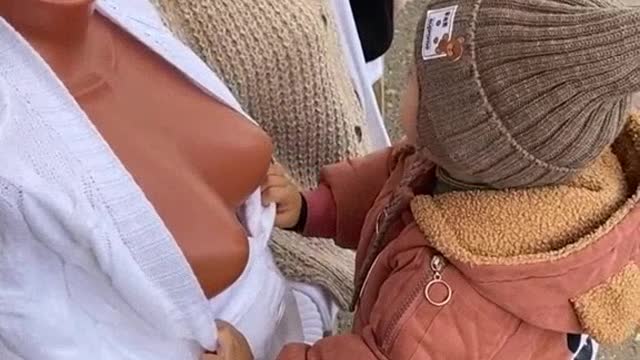 Little boy tastes a mannequin's chest